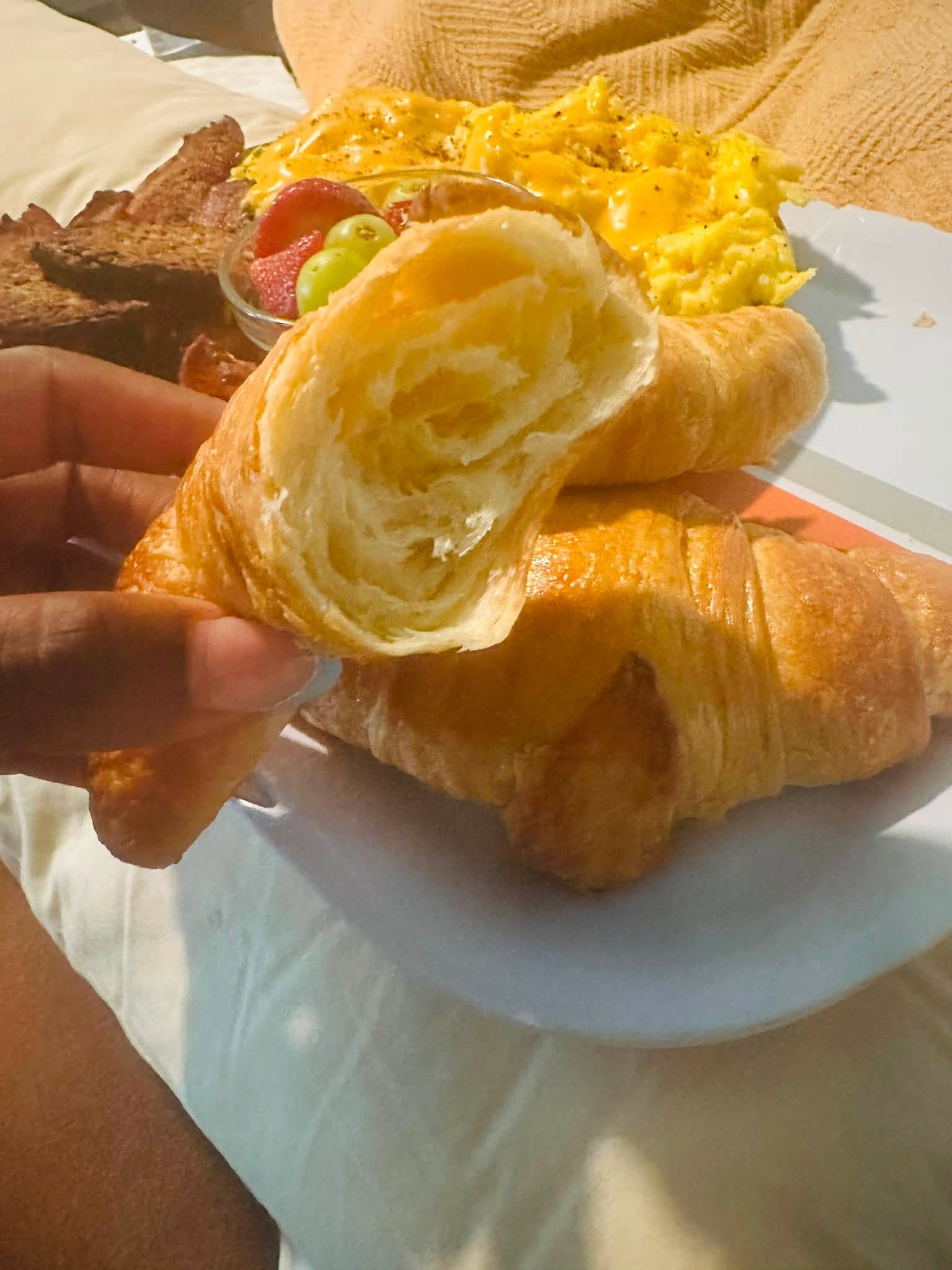 Board Friends Events breakfast cart — fresh croissants, scrambled eggs, bacon and fruit