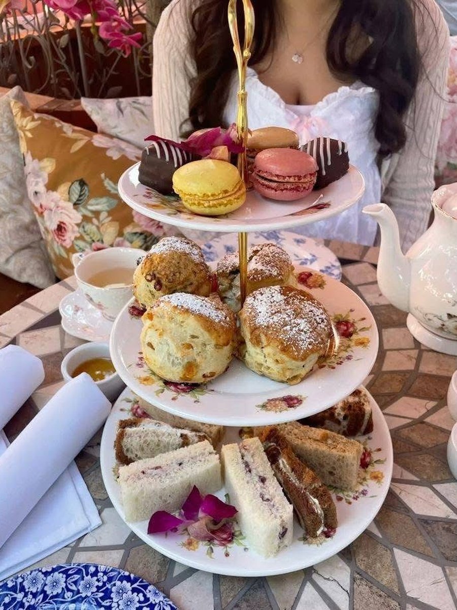 Board Friends Events dessert cart — elegant tiered stand with macaroons, scones, pastries and finger sandwiches